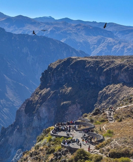 Panoramic view of Colca Canyon in Peru, one of the deepest canyons in the world, with dramatic cliffs and winding river | Andean Travel Experience