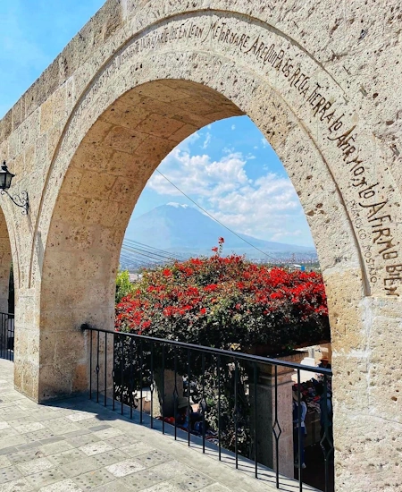 View from the Yanahuara Mirador in Arequipa, Peru, featuring archways with volcanic stone | Andean Travel Experience