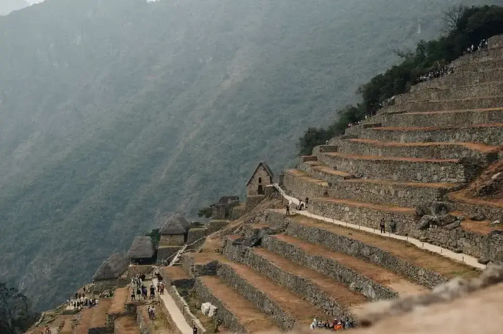 Machu Picchu ruins during cloudy day Tours Peru | Andean Travel Experience