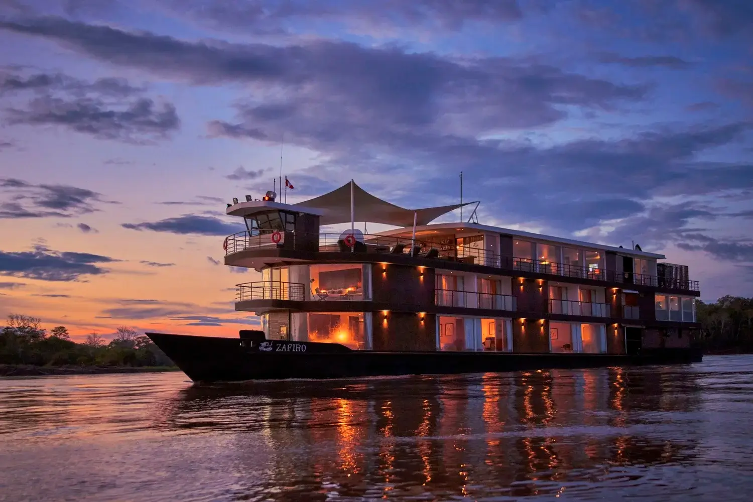 Exterior view of the Zafiro luxury river cruise in the Amazon at Sunset | Andean Travel Experience