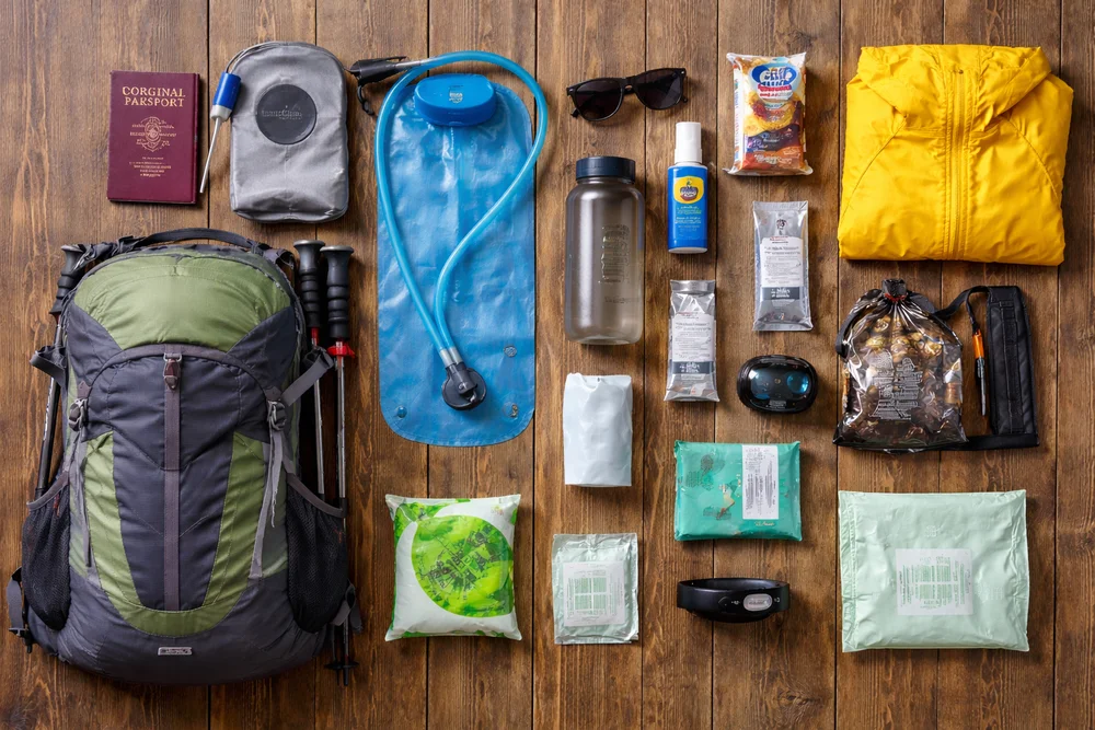 Porter carrying duffel bag on the Inca Trail with mountains in the background | Andean Travel Experience