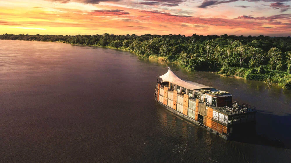 Golden sunset over the Peruvian Amazon viewed from the deck of a luxury river cruise | Andean Travel Experience Golden sunset over the Peruvian Amazon viewed from the deck of a luxury river cruise | Andean Travel Experience