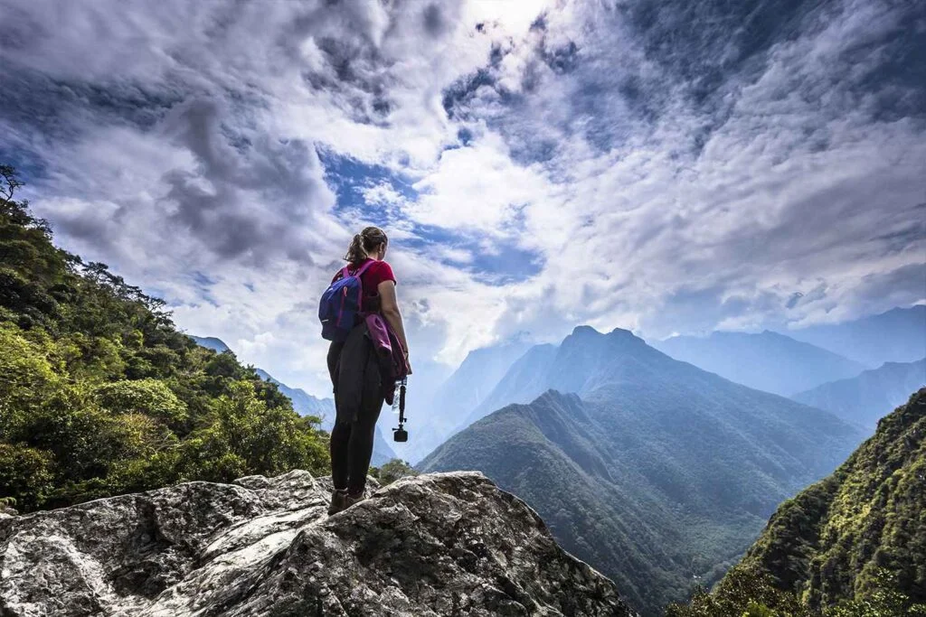 Female traveler admiring the inca trail route | Andean Travel Experience