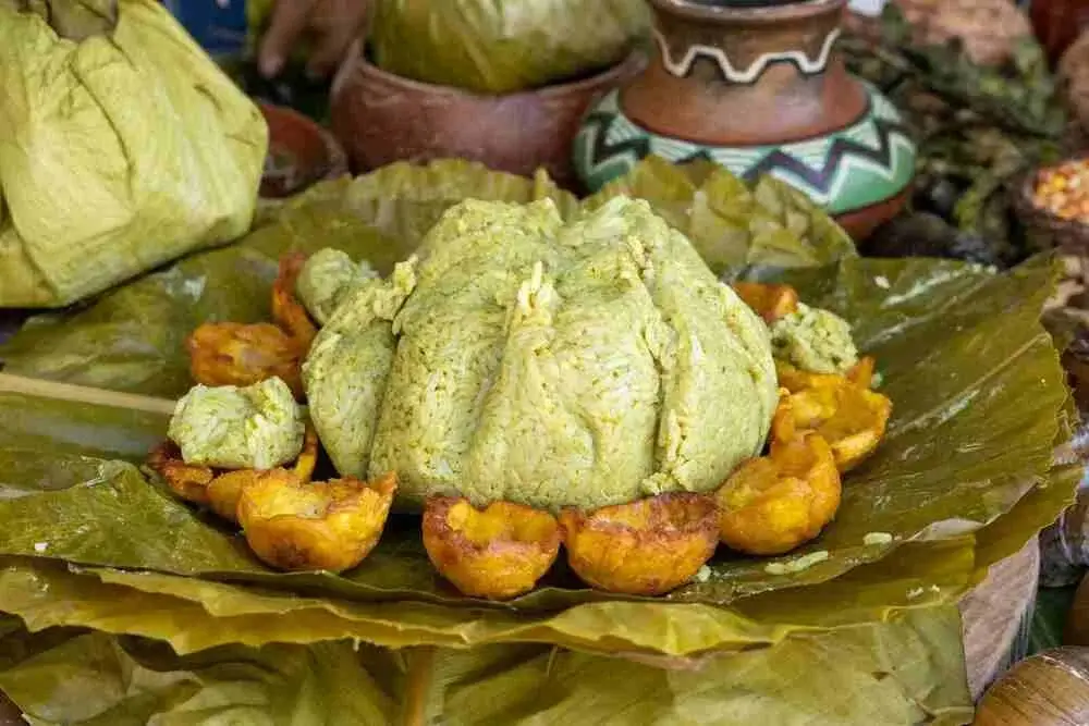 Traditional Amazonian juane a rice dish wrapped in bijao leaves, filled with chicken, olives, and egg, typical of Peru’s jungle region. | Andean Travel Experience