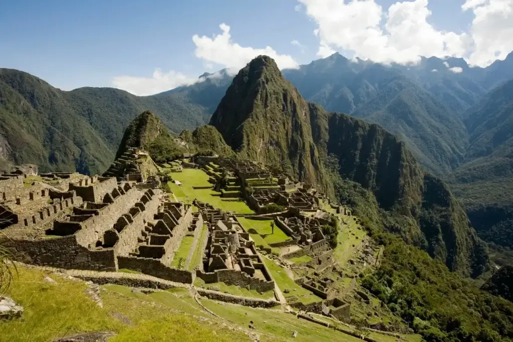 Panoramic view of Machu Picchu with Huayna Picchu mountain in the background on a clear sunny day | Andean Travel Experience