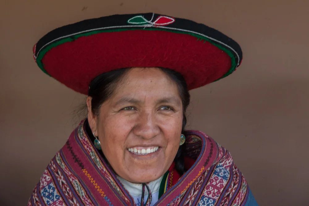 Nilda Callañaupa, master Andean weaver, wearing traditional Quechua clothing and working with hand-woven textiles in the Sacred Valley, representing the preservation of ancestral Peruvian weaving traditions | Andean Travel Experience