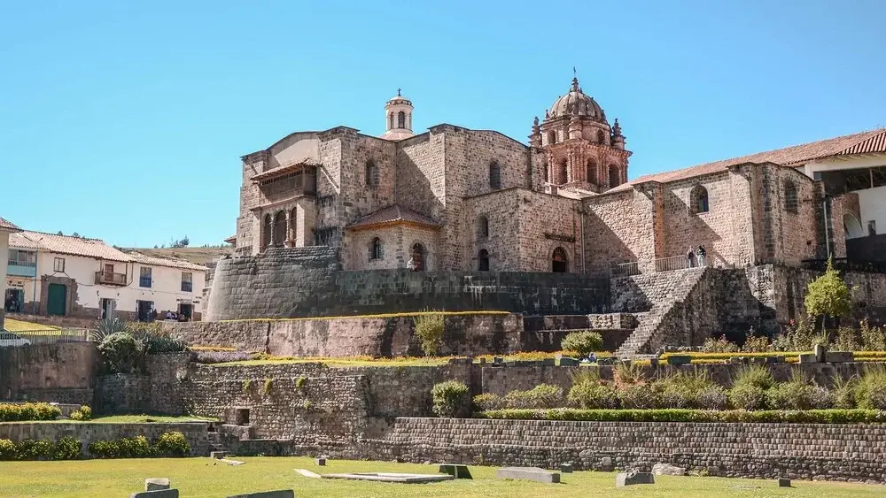 ront view of Qoricancha Temple in Cusco, Peru, showcasing Inca stone walls and the Santo Domingo Convent | Andean Travel Experience