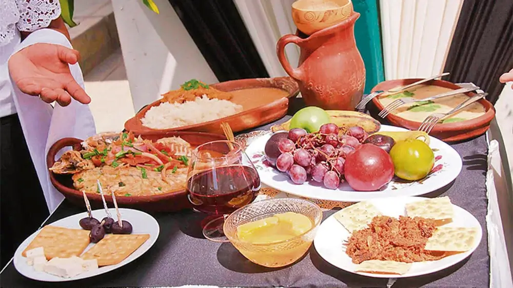 Traditional Peruvian Easter dishes served on a rustic table, featuring fish, soups, and regional specialties prepared during Semana Santa. | Andean Travel Experience Traditional Peruvian Easter dishes served on a rustic table, featuring fish, soups, and regional specialties prepared during Semana Santa. | Andean Travel Experience