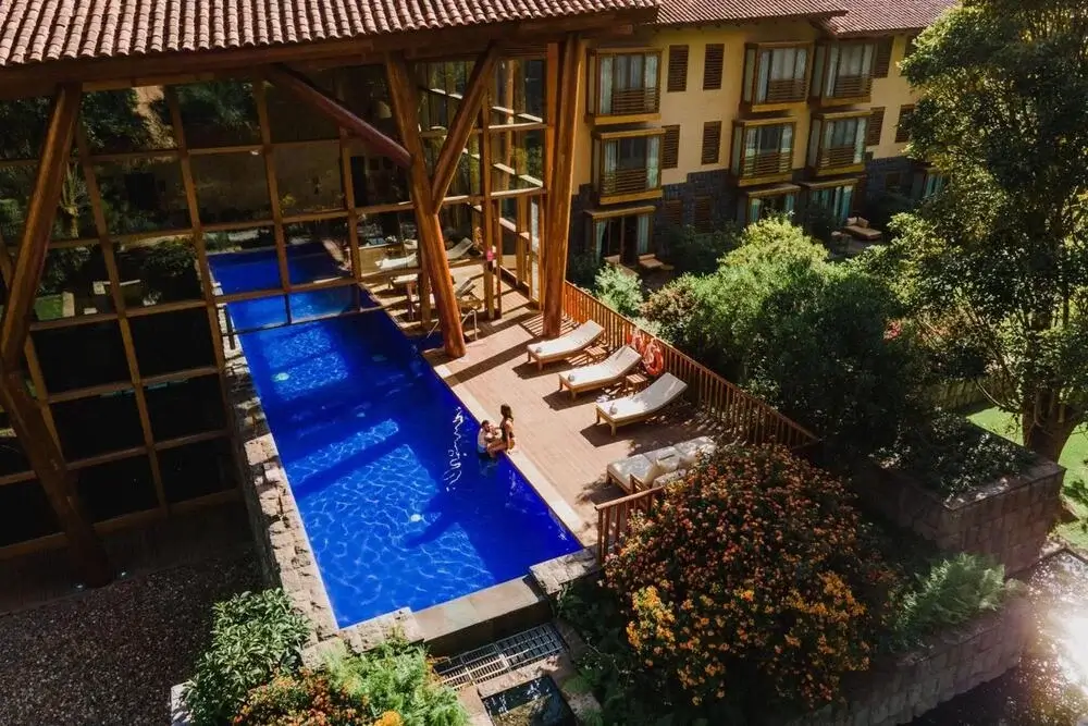 Tambo del Inka hotel in the Sacred Valley, Peru, featuring luxury accommodations with modern amenities, an infinity pool, and views of the surrounding Andes mountains. | Andean Travel Experience