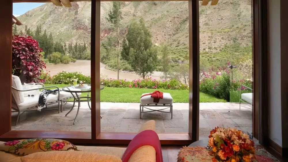 Belmond Hotel in the Sacred Valley, Peru, featuring luxurious accommodations surrounded by lush gardens, terraced hillsides, and panoramic Andean mountain views. | Andean Travel Experience