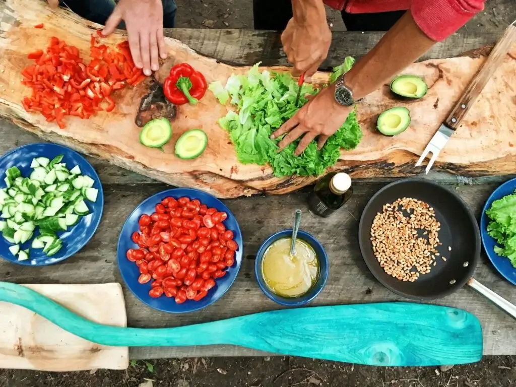 Traveler participating in a traditional Peruvian cooking class in Cusco, preparing local dishes with fresh ingredients. | Andean Travel Experience