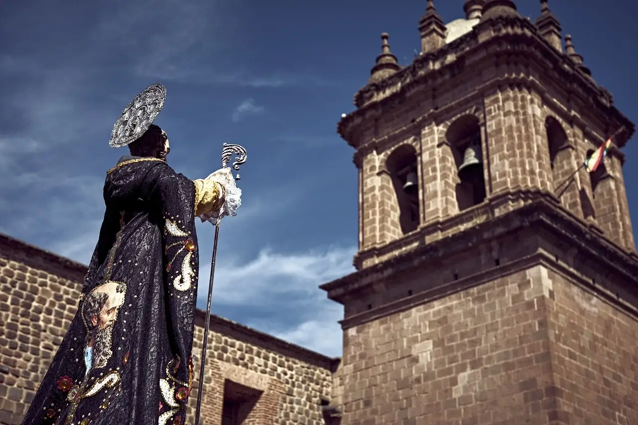 Colorful Corpus Christi celebration in Cusco with traditional Andean dancers, religious processions, and decorated saints carried through the main square | Andean Travel Experience