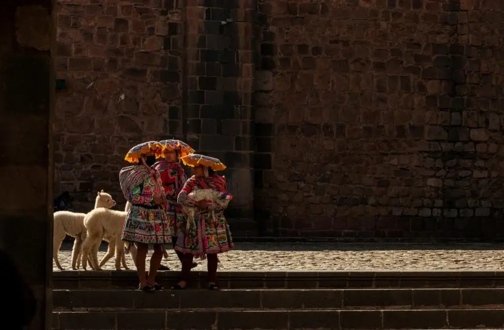 Traditional Andean women in colorful attire at the cusco Plaza | Andean Travel Experience