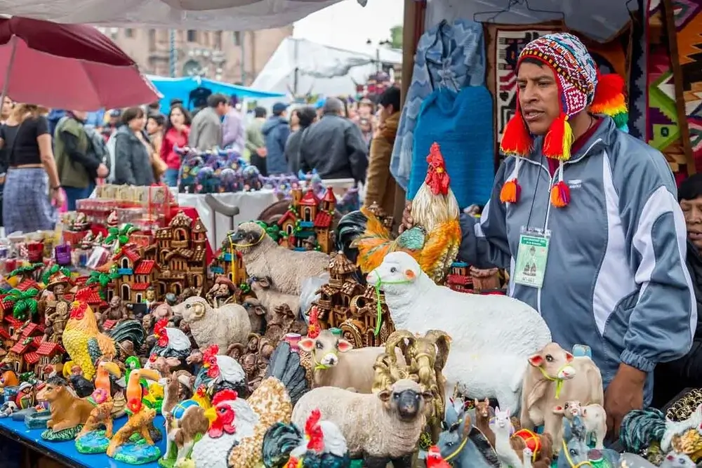 Traditional Christmas market in Peru with colorful Andean crafts, nativity scenes, and festive decorations filling the streets of Cusco during the holiday season | Andean Travel Experience