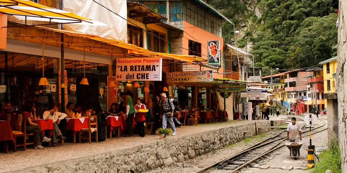 Restaurants in Aguas Calientes near the train station, offering Peruvian cuisine to travelers on their way to Machu Picchu. | Andean Travel Experience