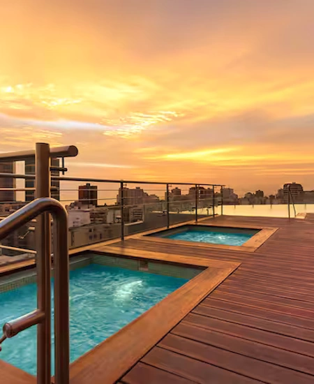 Rooftop pool at the Hilton Miraflores, featuring stunning sunset views over Lima | Andean Travel Experience