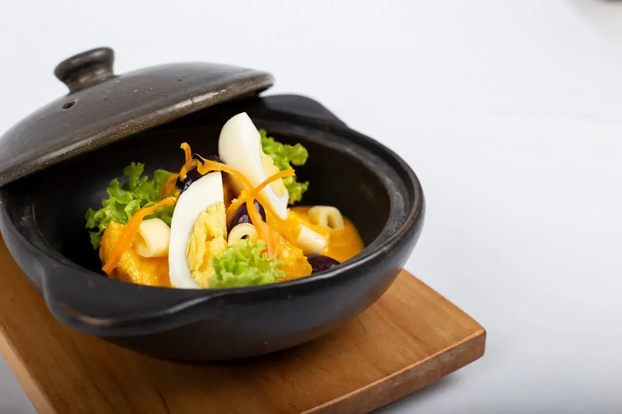 Papa a la huancaína – boiled potatoes topped with creamy, spicy Peruvian huancaína sauce, garnished with eggs and olives | Andean Travel Experience