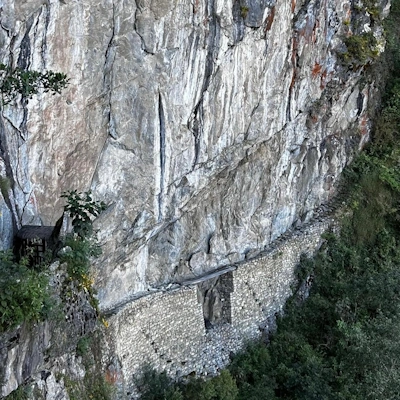 Inca Bridge at Machu Picchu, Peru – Ancient stone pathway built along a steep mountainside | Andean Travel Experience