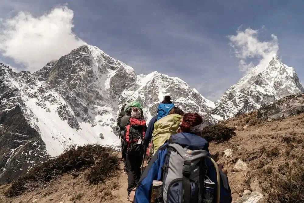 Hikers on the Inca Trail with a snow-capped Andean peak in the background | Andean Travel Experience