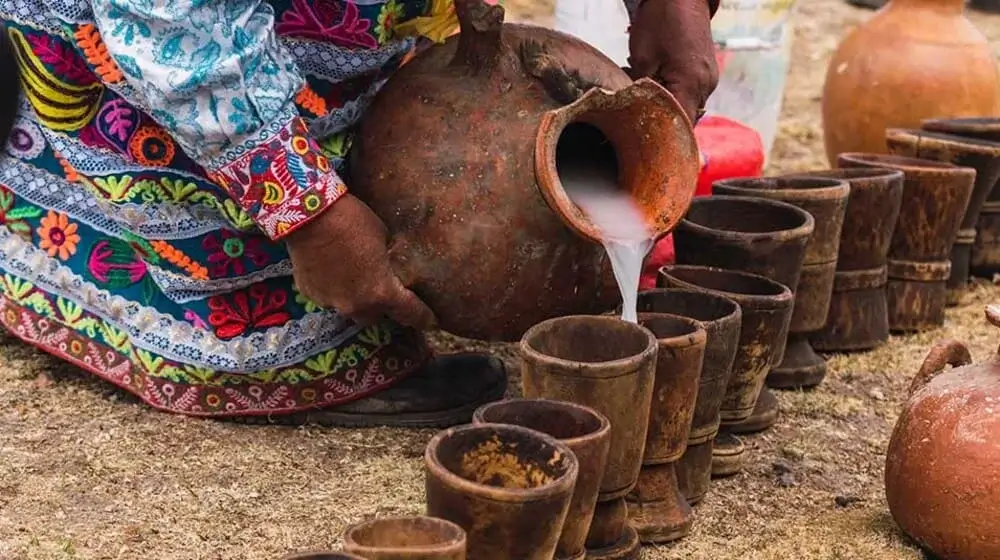 Traditional Chicha de Jora fermented corn drink in a rustic clay cup, representing ancient Incan beverage traditions | Andean Travel Experience