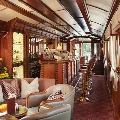 Interior view of a luxury train to Machu Picchu, featuring elegant seating and stylish decor | Andean Travel Experience