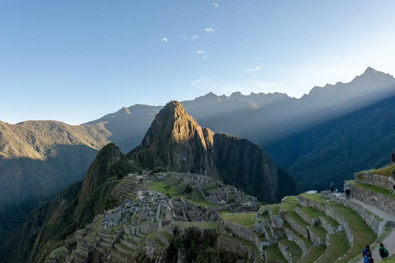 Drone view of Machu Picchu showing Inca citadel, stone terraces, and surrounding Andes mountains | Andean Travel Experience