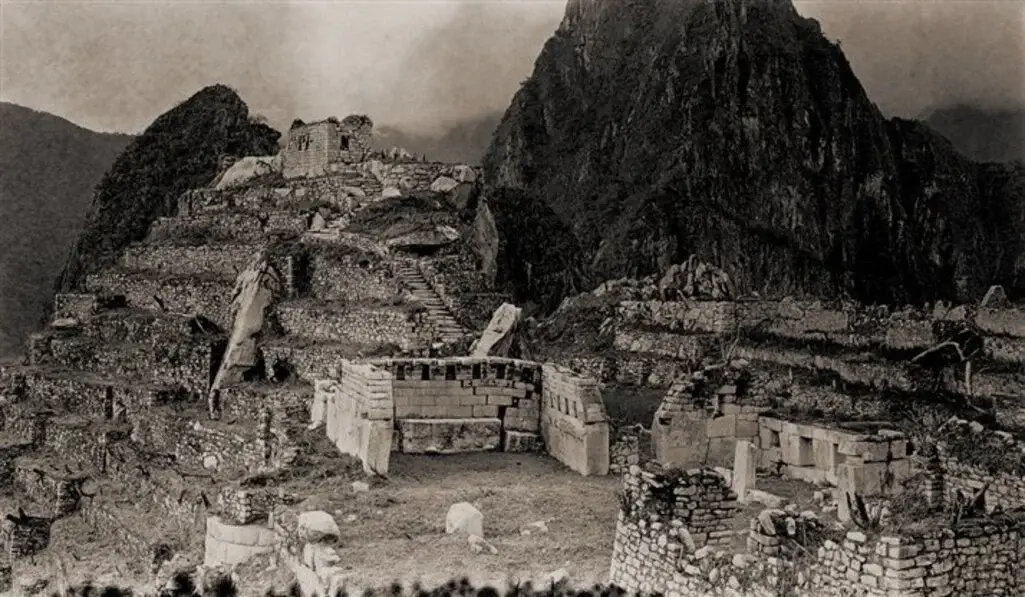 By: Hiram Bingham. Amazing architectural highlights of Machu Picchu’s Sacred Plaza include the Main Temple, the Temple of the Three Windows, and the Intiwatana stone above the holy mountaintop | Andean Travel Experience