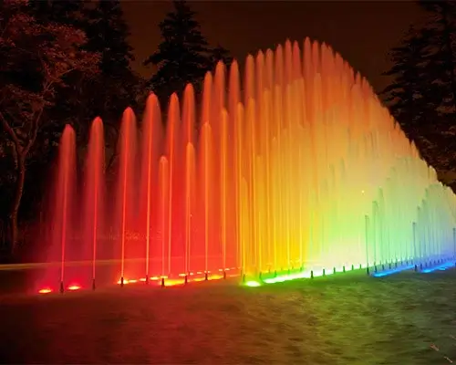 Night view of the Magic Water Circuit in Lima, Peru, with illuminated fountains creating a colorful water show | Andean Travel Experience