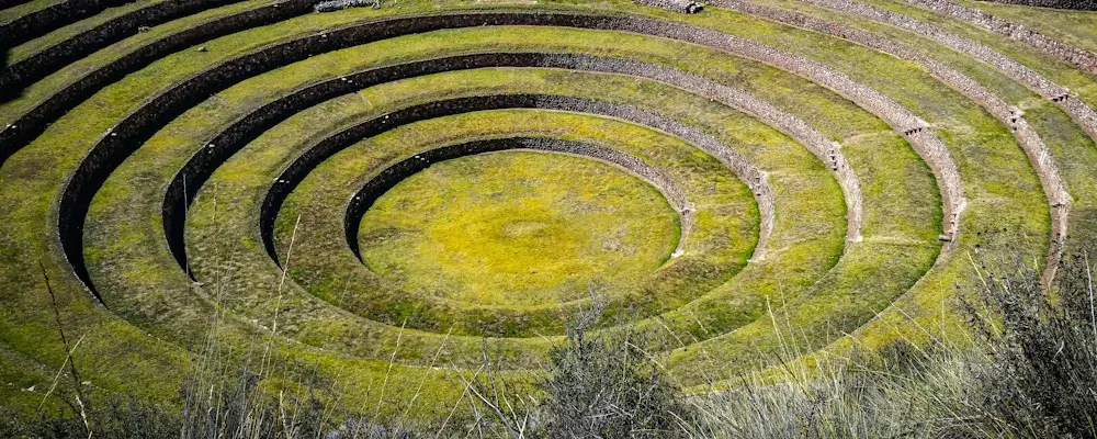 Sacred Andean mountains revered in Quechua culture, rising above rural highland landscapes. | Andean Travel Experience