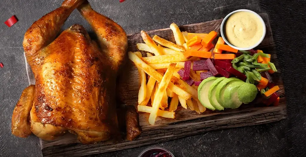 Juicy Pollo a la Brasa from Pardos Chicken, served with golden fries, fresh salad, and traditional Peruvian sauces. | Andean Travel Experience