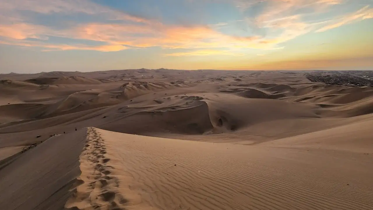 Sechura Desert dunes under a dramatic sunset sky in northern Peru | Andean Travel Experience
