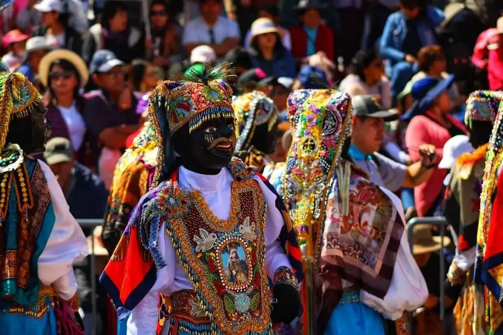 Colorful festive dances of the Virgen de la Candelaria festival in Puno, Peru, with performers in elaborate costumes and traditional Andean masks | Andean Travel Experience