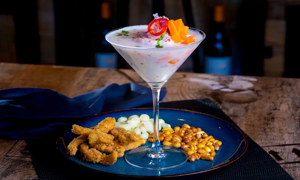 Traditional Peruvian ceviche served with fresh fish, lime juice, red onion, chili, and corn | Andean Travel Experience