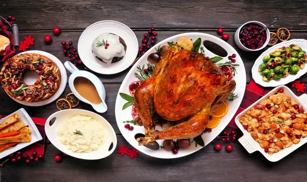 Peruvian Christmas dinner table with roast turkey, hot chocolate, panettone, and traditional Andean dishes shared by families during the holiday celebration | Andean Travel Experience