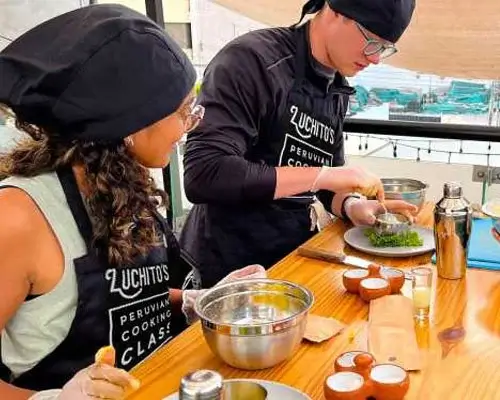 Participants in a Peruvian cooking class, learning to prepare traditional dishes with fresh local ingredients | Andean Travel Experience