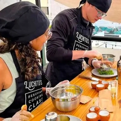 Participants in a Peruvian cooking class, learning to prepare traditional dishes with fresh local ingredients | Andean Travel Experience.