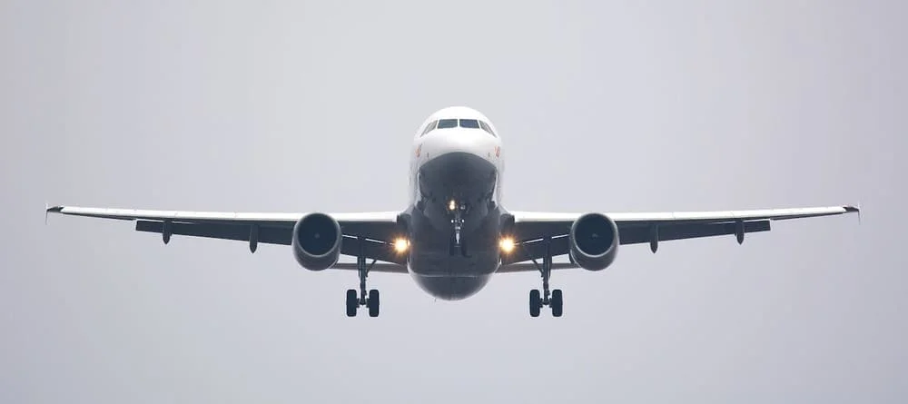 commercial airplane flying to Peru with blue skies in background | Andean Travel Experience