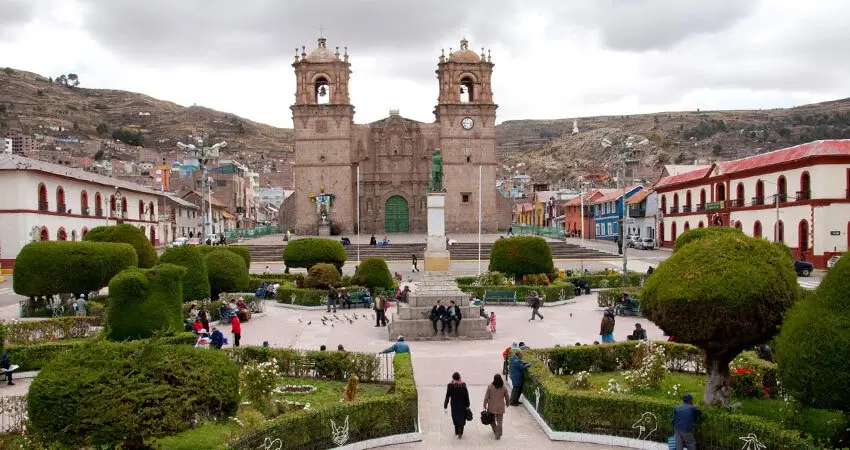 Aerial view of Puno city and Lake Titicaca surrounded by Andean mountain | Andean Travel Experience