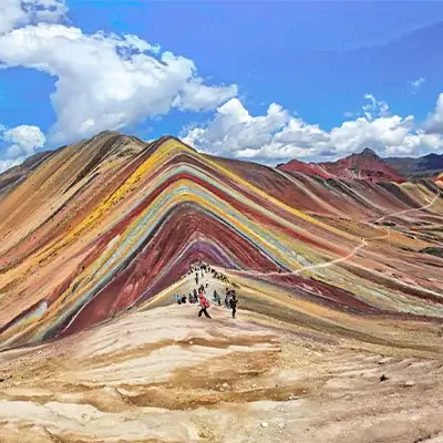 Rainbow Mountain (Vinicunca) in Peru, showcasing its vibrant, multi-colored stripes | Andean Travel Experience