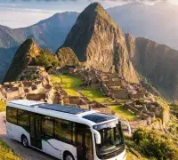 Vertical image of Machu Picchu at sunrise with a modern electric tour bus in the foreground and headline text about electric vehicles protecting the Inca heritage site.