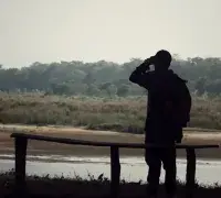 Birdwacthing Locations Peru Man Standing in Front of lagoon looking at birds
