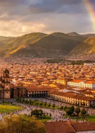 Aerial view of Cusco’s historic center with red-tiled rooftops and colonial architecture in the Peruvian Andes. | Andean Travel Experience