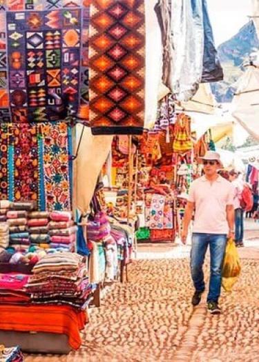 Traditional Andean weavers selling handmade alpaca textiles at Chinchero Market near Cusco | Andean Travel Experience Traditional Andean weavers selling handmade alpaca textiles at Chinchero Market near Cusco | Andean Travel Experience