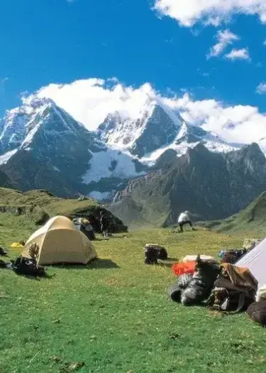 Sunset over Laguna Jahuacocha campsite with snow-covered peaks in the Cordillera Huayhuash | Andean Travel Experience