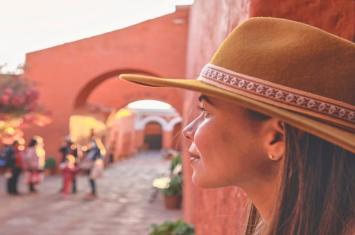 Tourist admiring the Monastery of Santa Catalina in Arequipa, Peru, with its colorful colonial architecture and historic courtyards | Andean Travel Experience