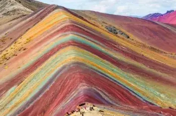 Rainbow Mountain, a stunning natural wonder in the Andes of Peru, known for its vibrant, multicolored slopes | Andean Travel Experience