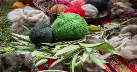 Hand-spun wool yarn dyed with natural colors in the Andes, showcasing vibrant hues | Andean Travel Experience