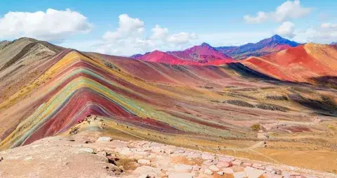 Rainbow Mountain, a stunning natural wonder in the Andes of Peru, known for its vibrant, multicolored slopes | Andean Travel Experience