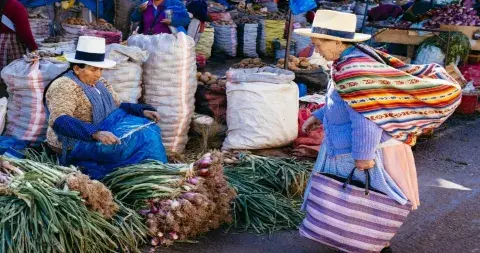 Mercado San Pedro in Cusco, bustling with local vendors and colorful produce, showcasing traditional Peruvian culture | Andean Travel Experience