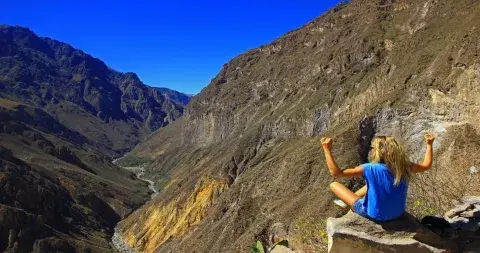 Woman relaxing and enjoying the breathtaking views of the Andean mountains | Andean Travel Experience